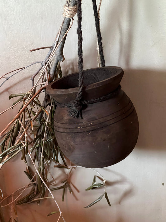Round Nepalese pots on rope