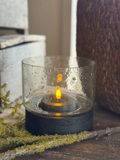 Hurricane lamp with black wooden base and bubble glass