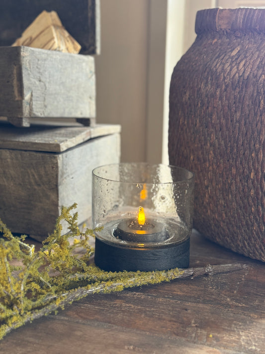 Hurricane lamp with black wooden base and bubble glass
