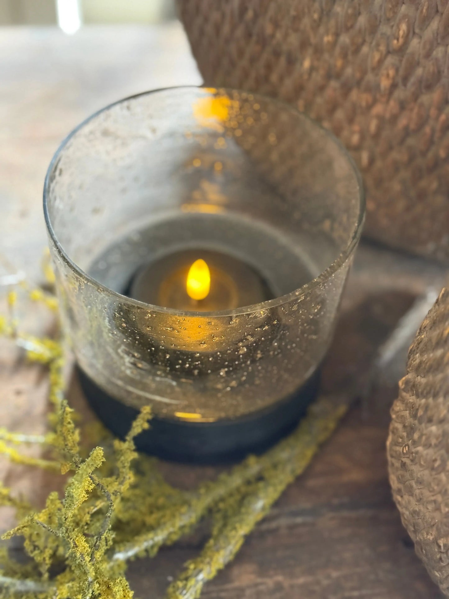 Hurricane lamp with black wooden base and bubble glass