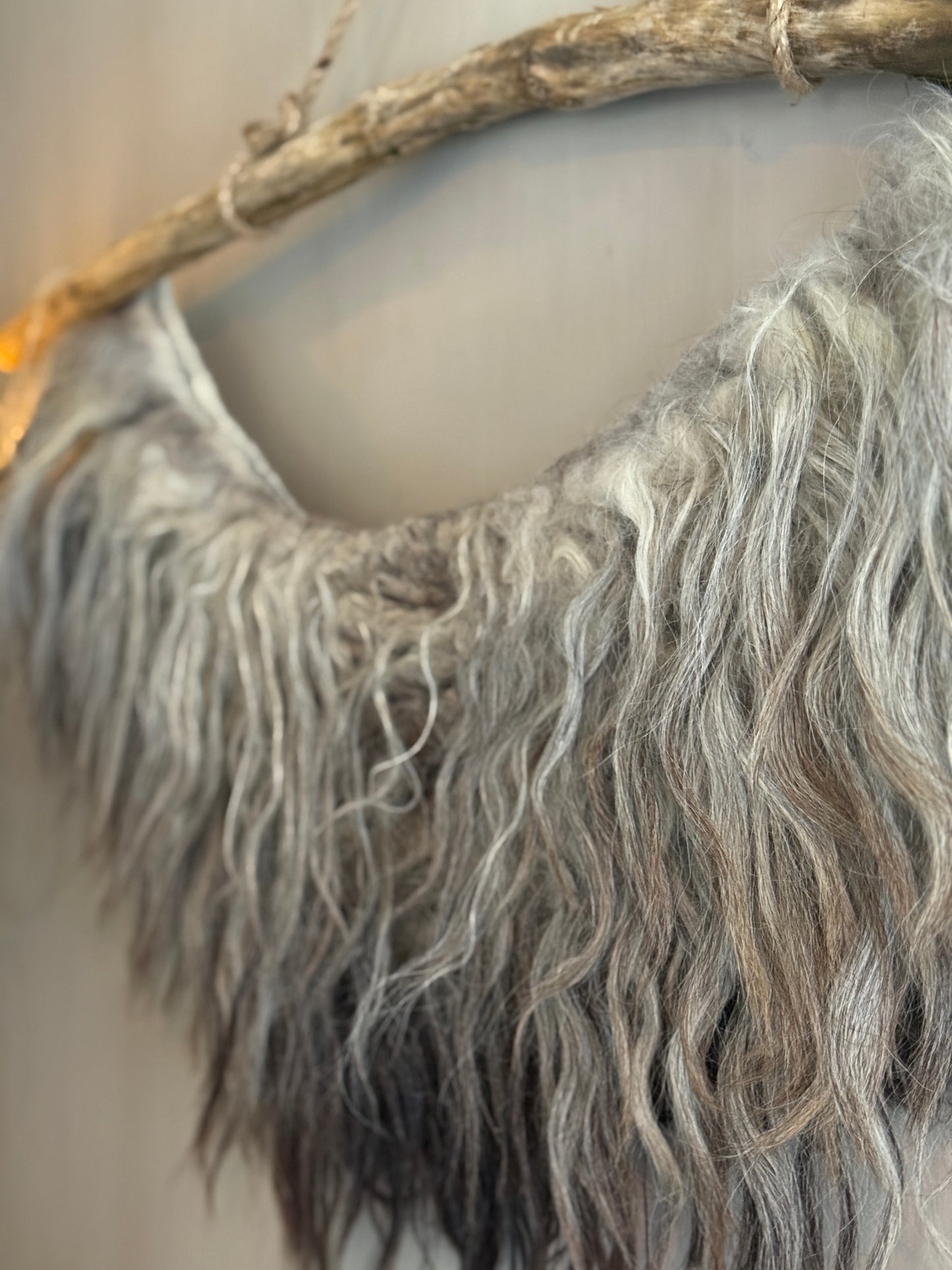 Felted sheepskin wall collar on a stick (LH05)