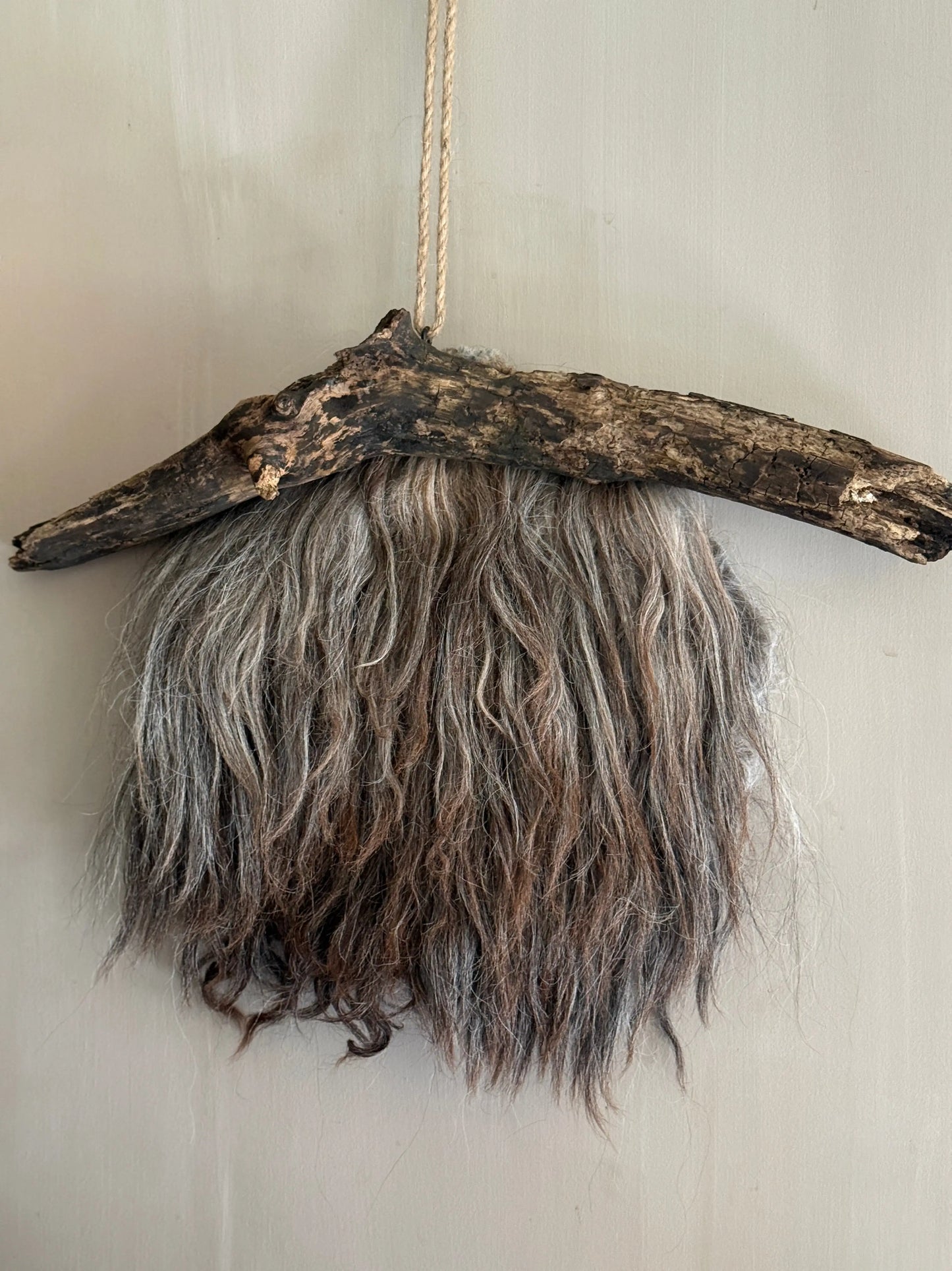 Felted sheepskin wall hanging on stick (LH08)
