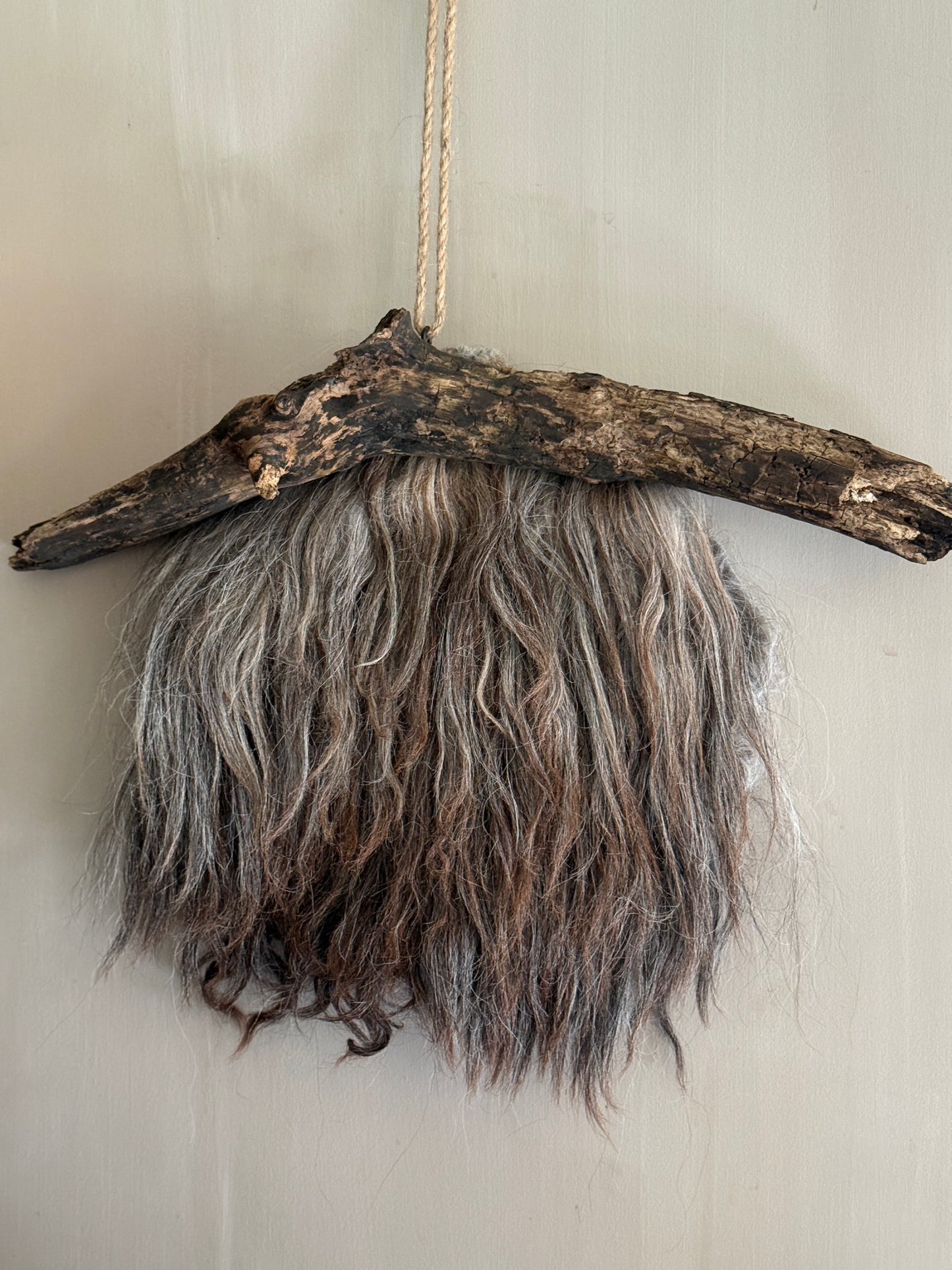 Felted sheepskin wall hanging on stick (LH08)