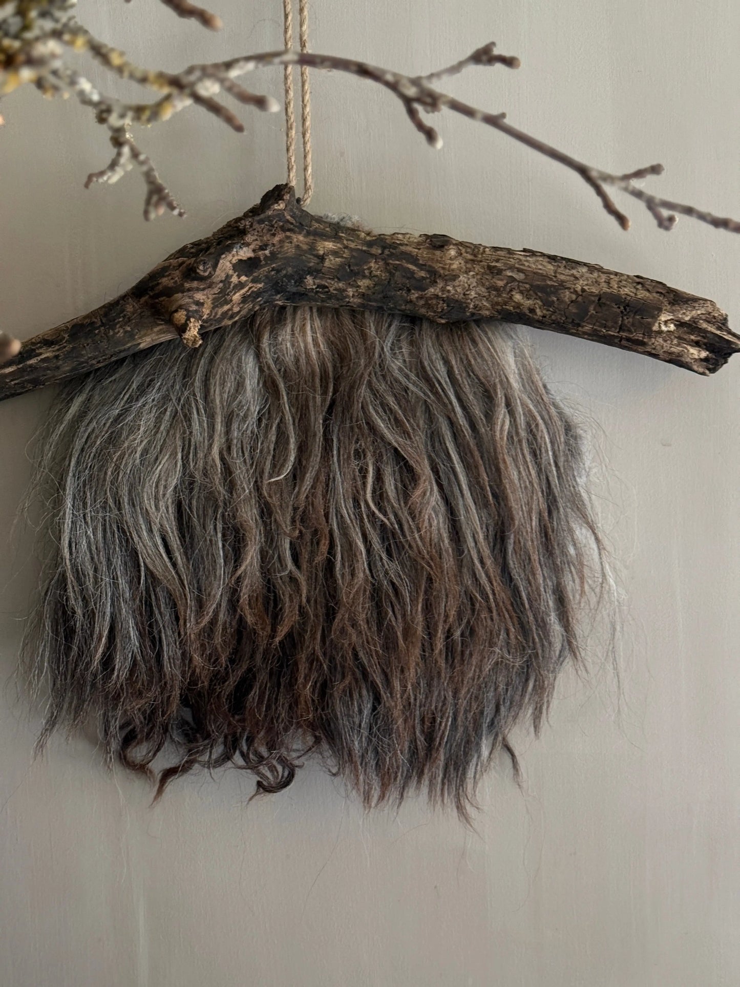 Felted sheepskin wall hanging on stick (LH08)