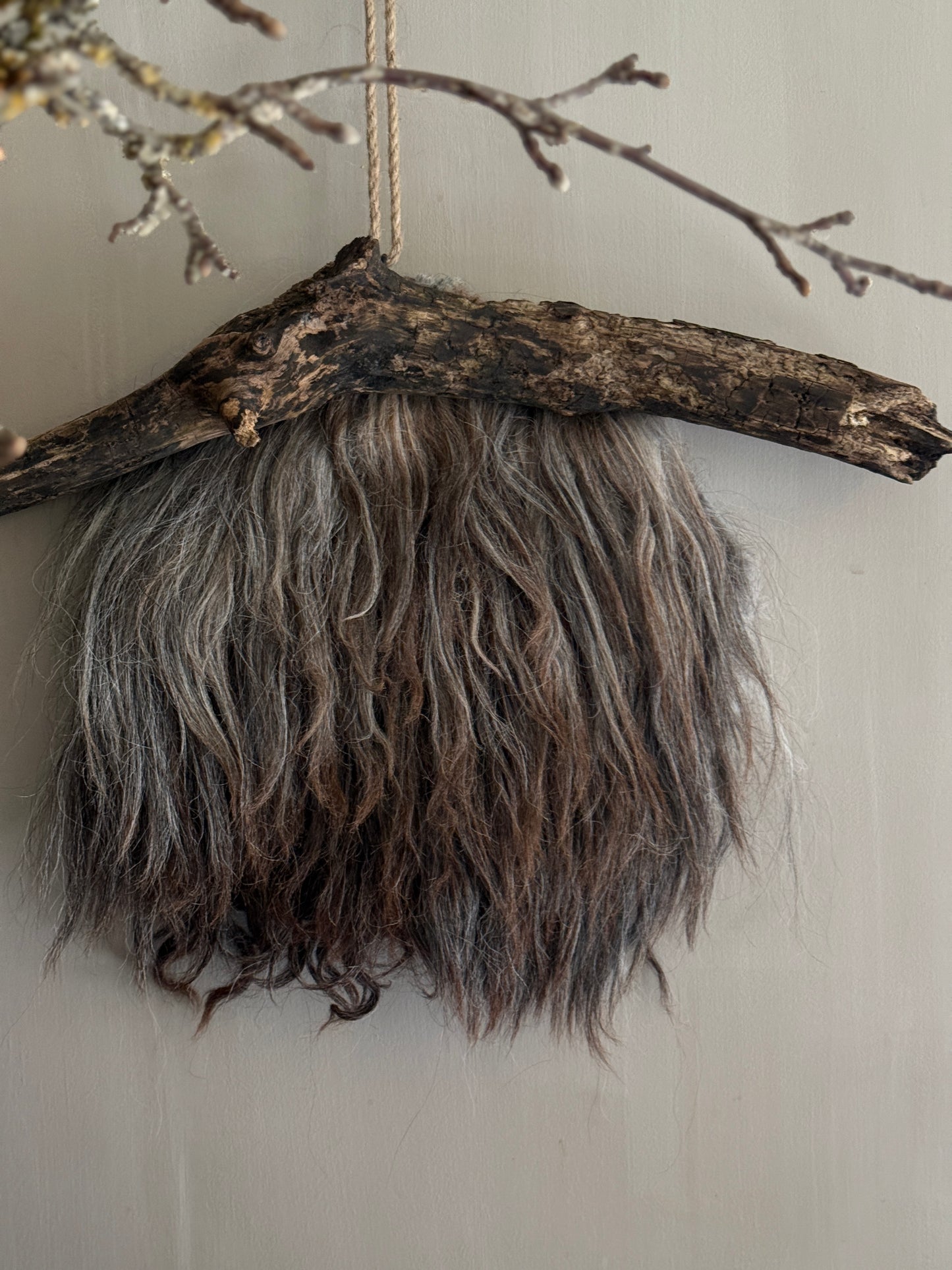 Felted sheepskin wall hanging on stick (LH08)