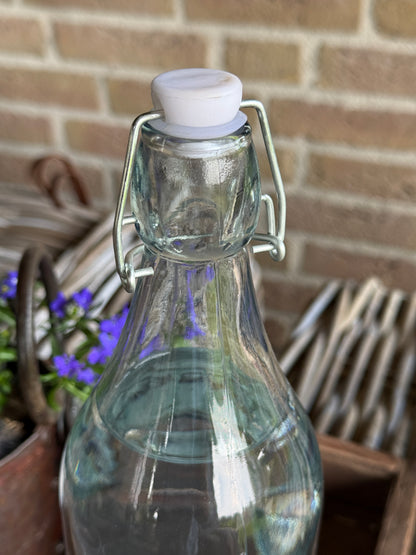 Swing-top bottle of processed clear glass