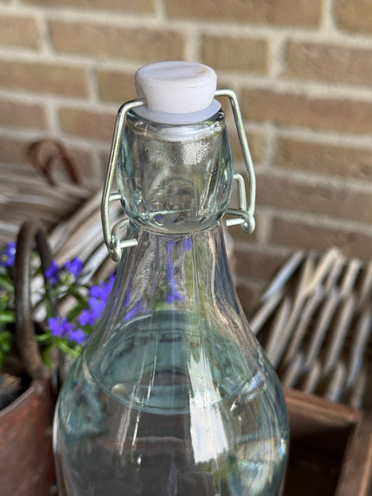 Swing-top bottle of processed clear glass