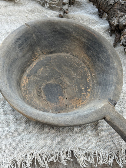 Weathered wooden bowl with a handle. (LH002)