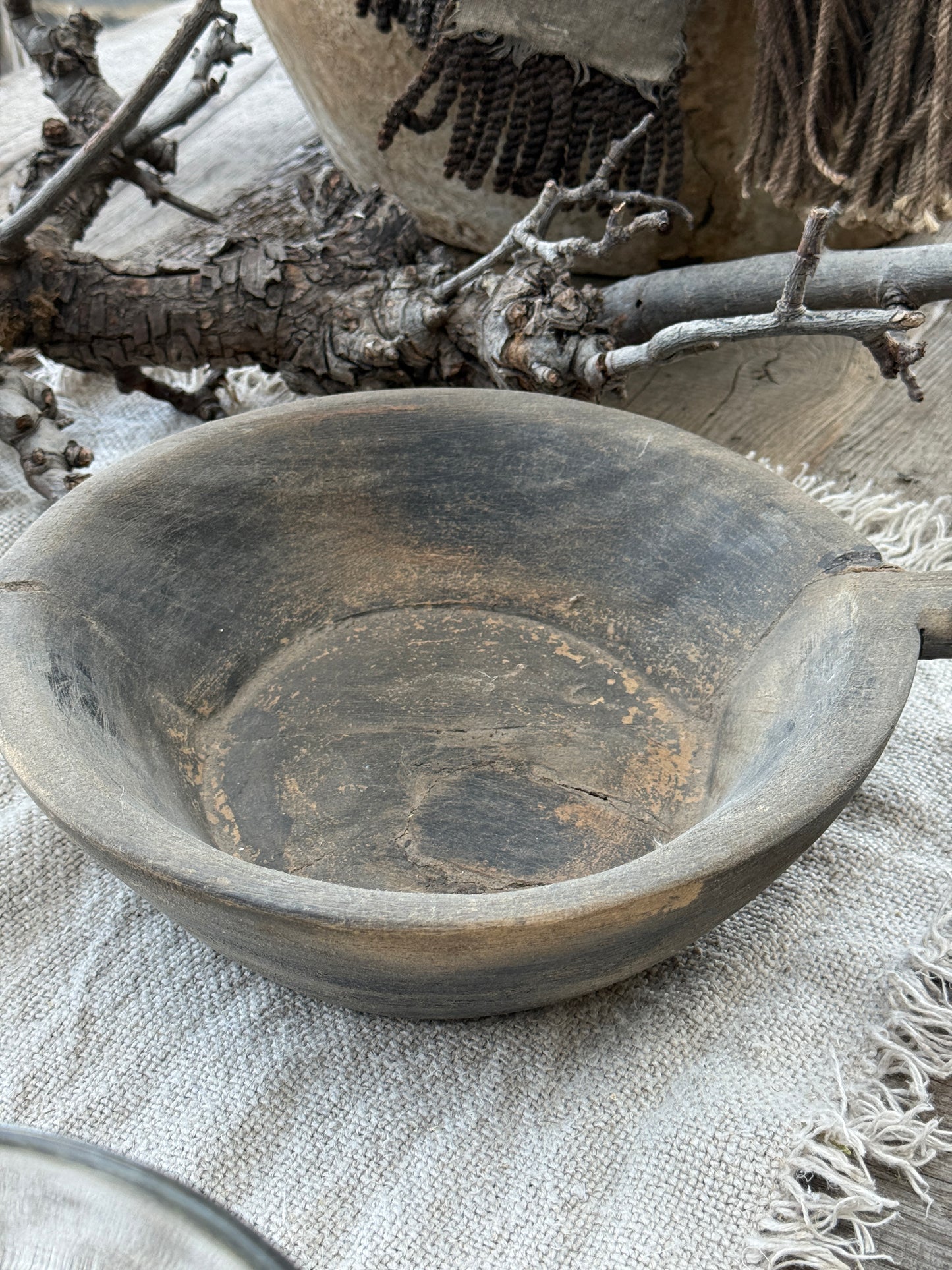 Weathered wooden bowl with a handle. (LH002)
