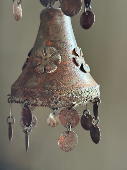 Two rusty metal bells on a chain
