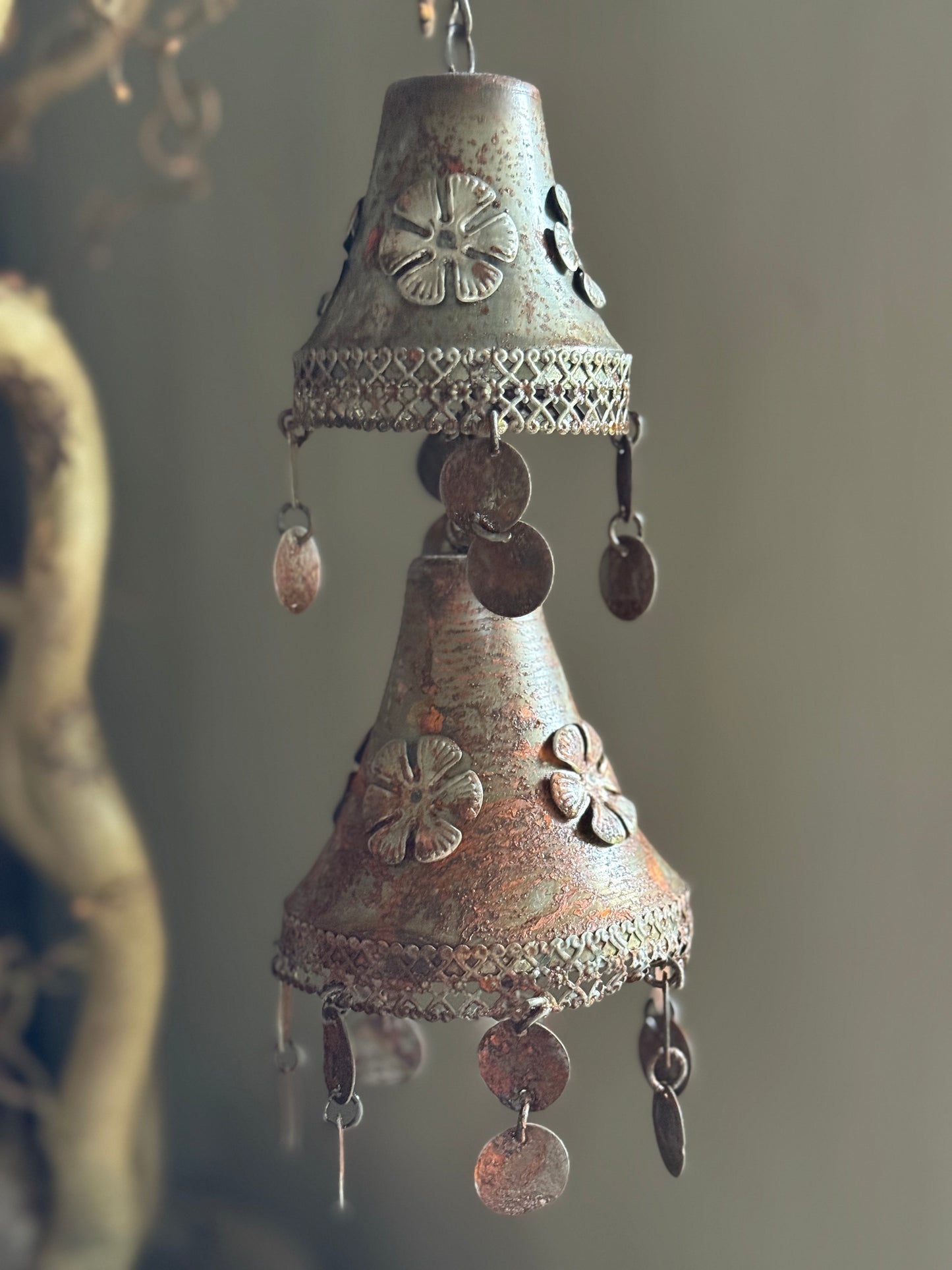 Two rusty metal bells on a chain