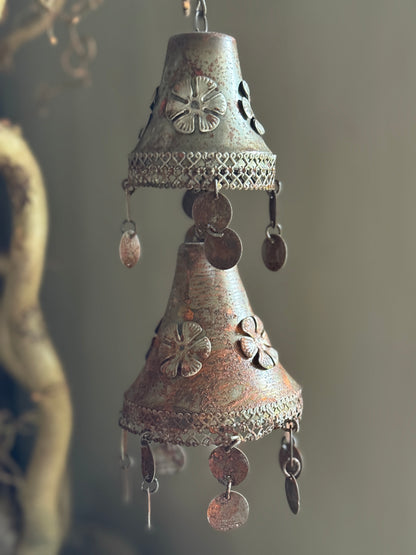 Two rusty metal bells on a chain