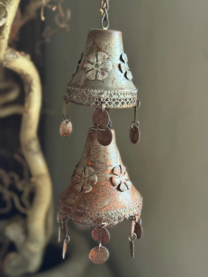 Two rusty metal bells on a chain