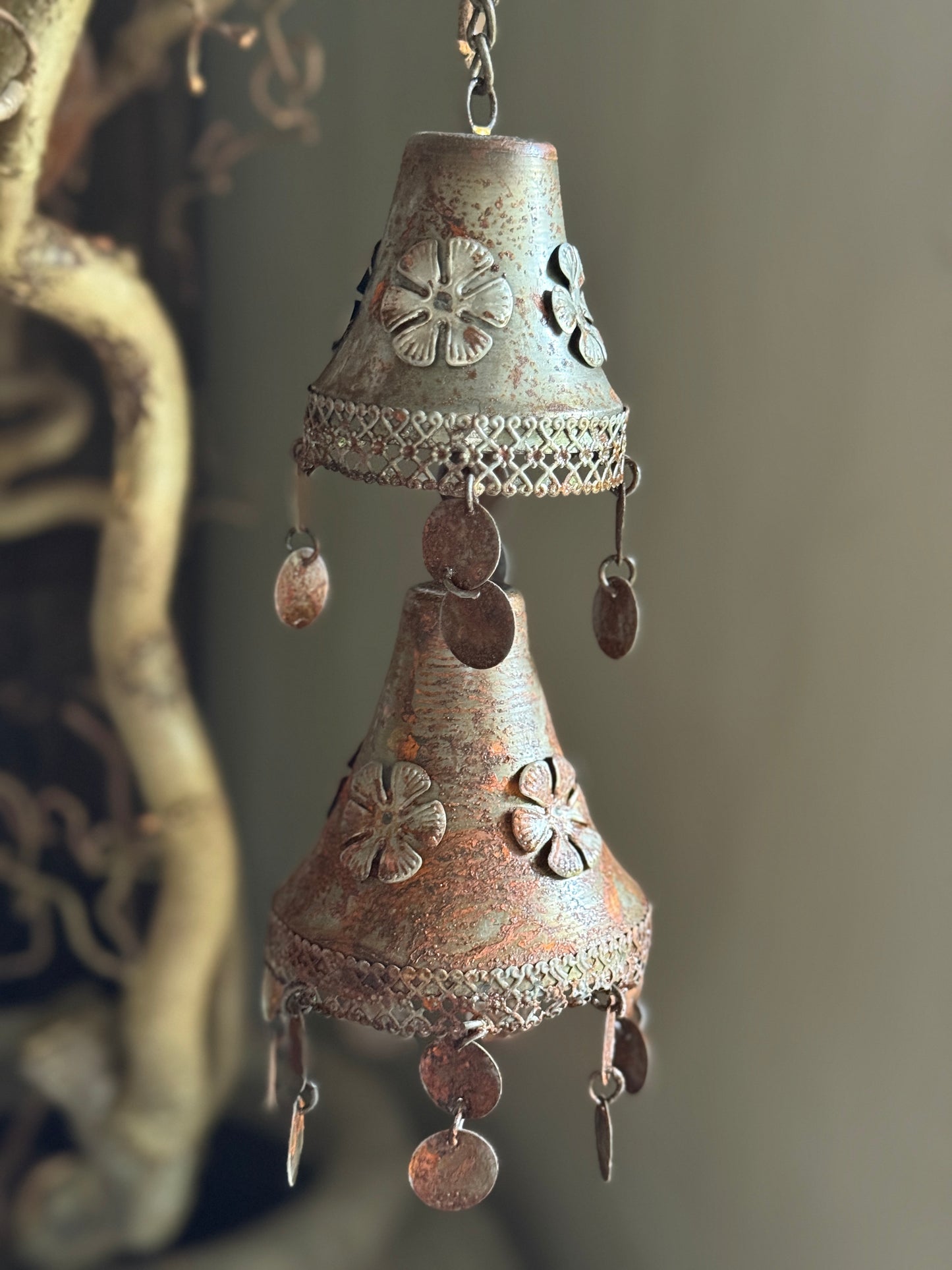 Two rusty metal bells on a chain