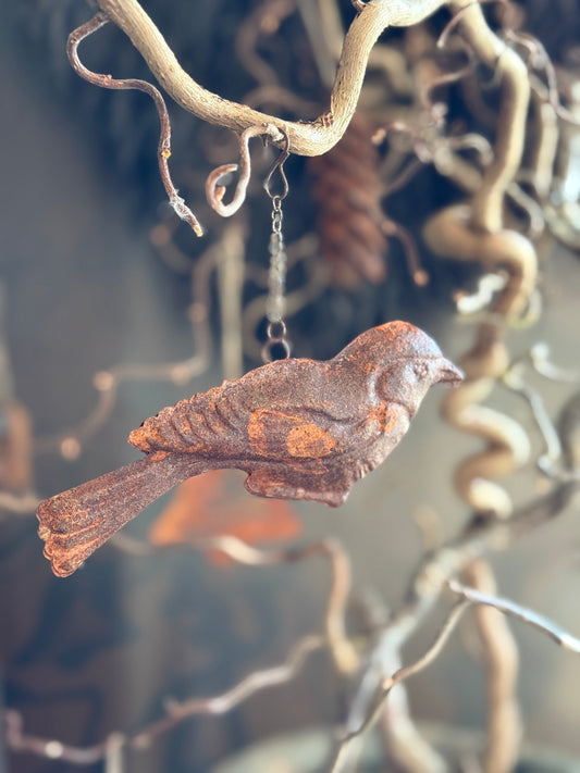 Rusted bird on a chain