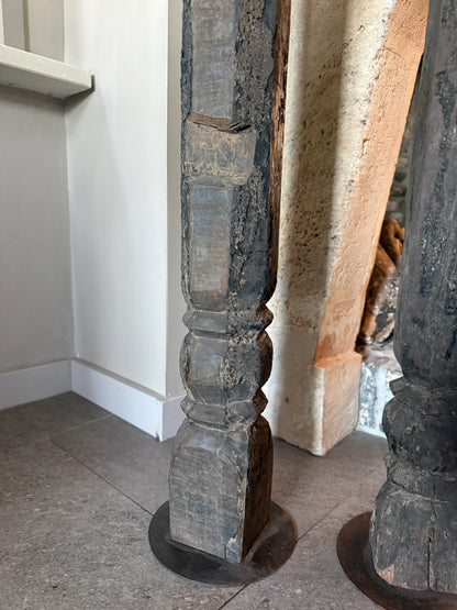 Oude hoge baluster kandelaar op metalen voet, linker op de afbeelding