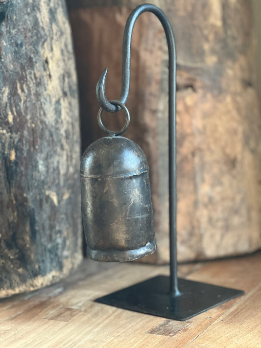 Metal bell on tripod